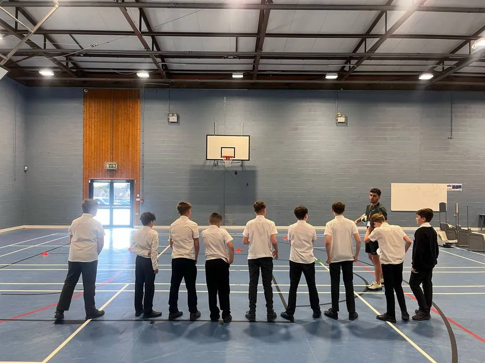 School sports hall session with pupils in a line