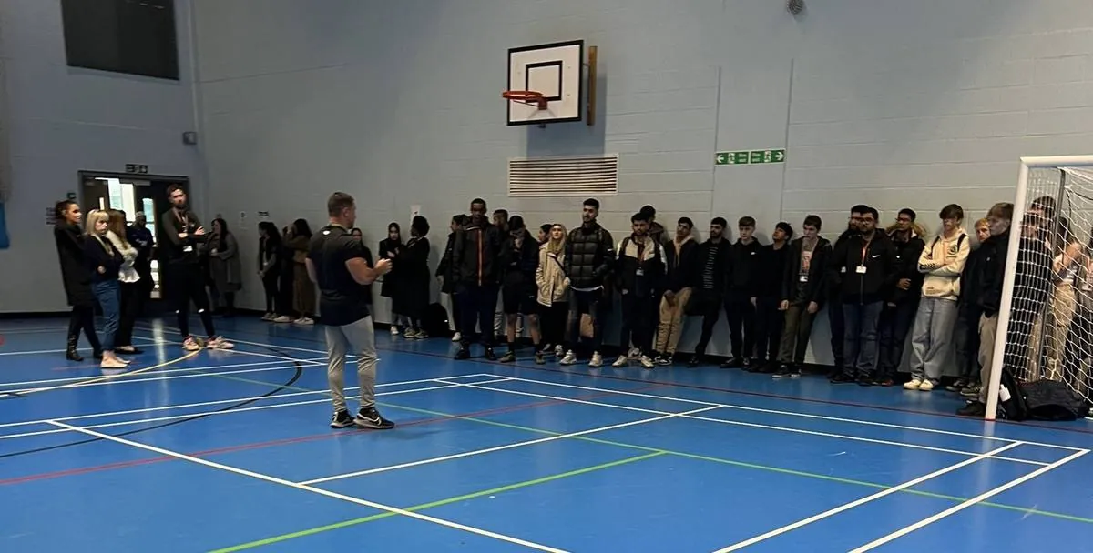 David addressing a large group at Bolton College
